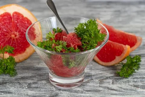 Summer salad with grapefruit on a light background with herbs. 스톡 사진