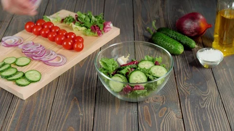 Summer salad. Professional chef pours sliced purple onion in glass bowl Stock Footage 129746288