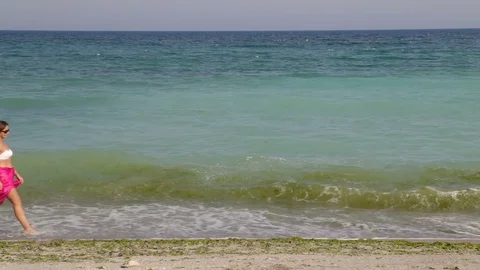 Summer scene of a beautiful young on the beach Stock Footage 80279465