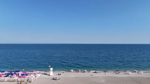 Summer scenery with people sunbathing at the beach by the sea Stock Footage 342286678