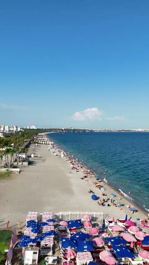Summer scenery with people sunbathing at the beach by the sea Stock Footage 342286737