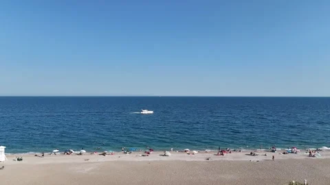 Summer scenery with people sunbathing at the beach by the sea Video stock 342540162