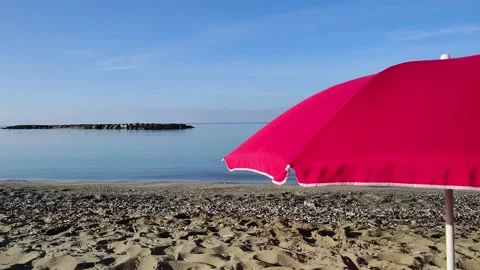 Summer Sea Landscape on the Beach. Close-up of a Red Beach Umbrella. Stock Footage 226737078