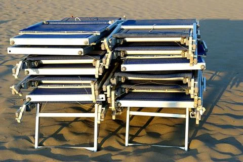 Summer sea,  stack of sunbeds on the beach Stock Photos