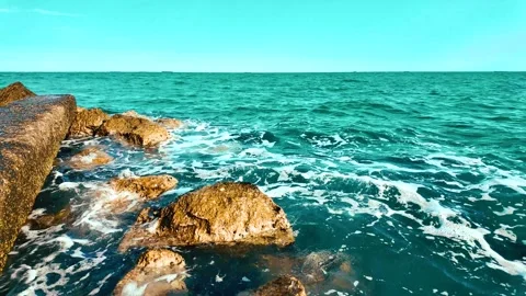 Summer sea waves between rocks on the beach Stock Footage 280248708