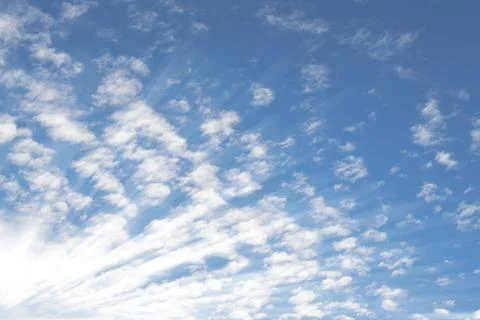 Summer sky with small Altocumulus clouds and bright sunrays sunbeams Stock Photos