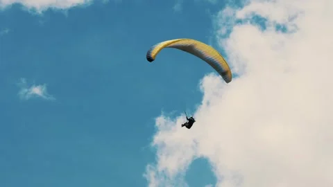 Summer Skydiving: Solo Paraglider Floating Against Clear Blue Sky Video stock 306154313