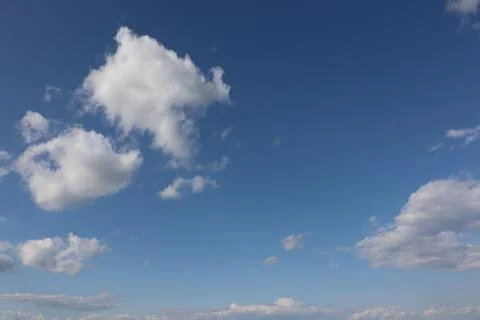 Summer small white clouds on blue sky background Stock Photos