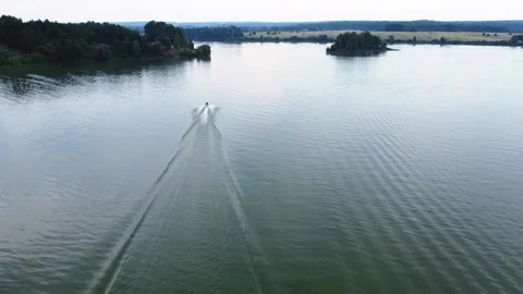Summer, smooth flight on a drone over the lake, on which a gyroscopic passes Video stock 163679174