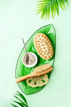 Summer spa setting background with cosmetic clay and massage brushes Stock Photos