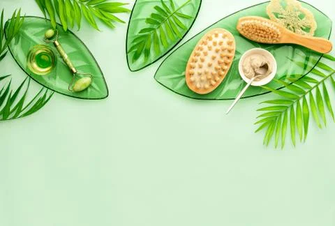 Summer spa setting background with cosmetic clay and massage brushes Stock Photos