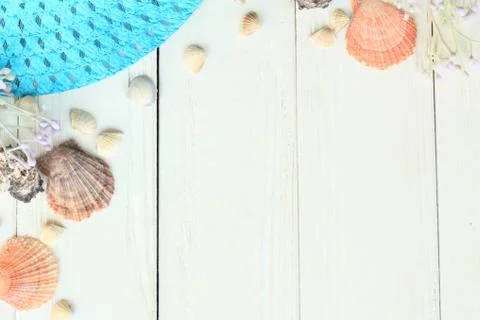 Summer straw hat and seashells on a wooden background.photo with place for text Stock Photos