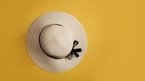 Summer straw hat on yellow background top view flat lay copy space. Stock Photos