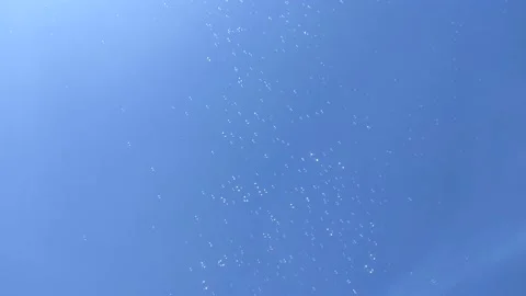 Summer sun and soap bubbles fly in the blue sky. Happiness, children's holiday. Stock Footage 156190856