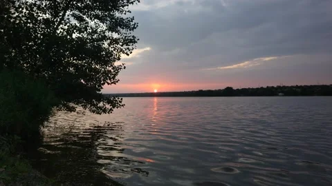 The summer sun sets over the river. Timelapse Stock Footage 158500157