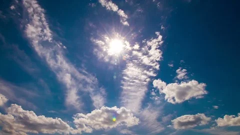 Summer sun shining in blue sky with white clouds Stock Footage 79049343