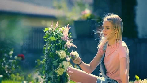 Summer sunny shiny holidays memories - blond smiling girl making a tender floral Stock Footage 83569953