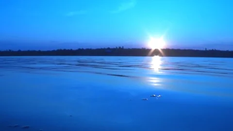 Summer sunset against a calm river with lens exposure effect 库存影片 117516182