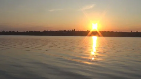 Summer sunset on the background of a calm river Stock Footage 117515321