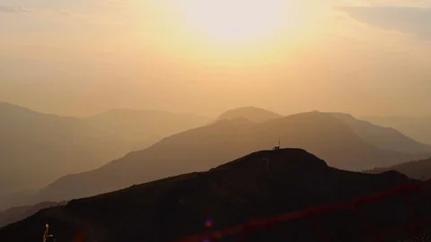 Summer sunset high in the mountains, which are shrouded in a slight fog. Stock Footage 107031582