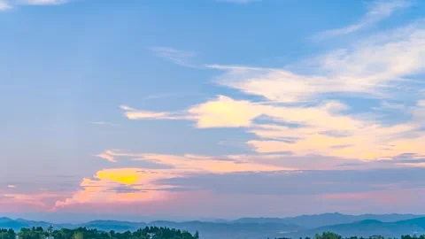 Summer Sunset Over Distant Mountain Ranges With Soft Pastel Clouds Moving Slowly Stock Footage 342217933