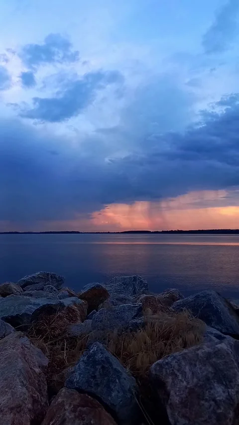 Summer Sunset Over River with Distant Thunderstorm and Rain Stock Footage 343004235
