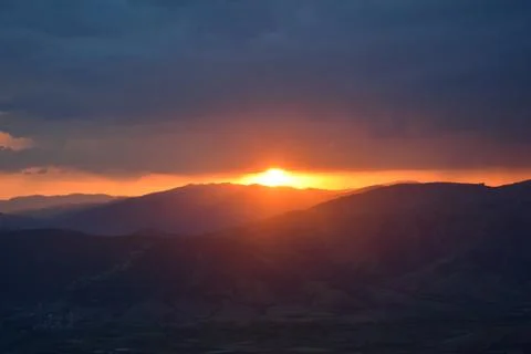 Summer sunset at overcast sky Stock Photos