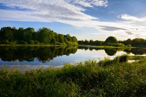Summer sunset on the river Stock Photos