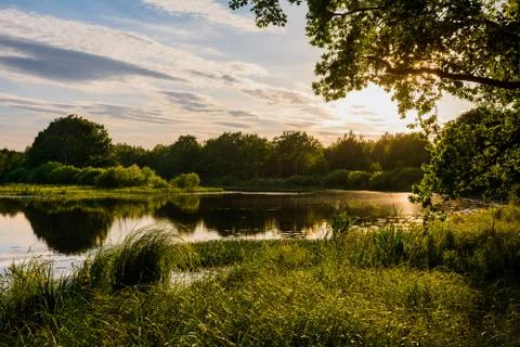 Summer sunset on the river Stock Photos