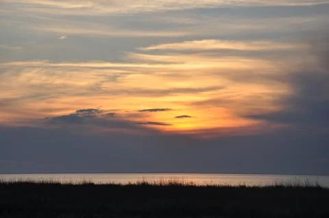 Summer sunset in the sea Stock Photos