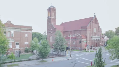 A Summer Sunset Timelapse of Traffic Passing Incarnation Catholic Church Stock Footage 144411495