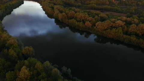 Summer sunset twilight from a drone flying over a forest lake and forest below Stock Footage 217742556
