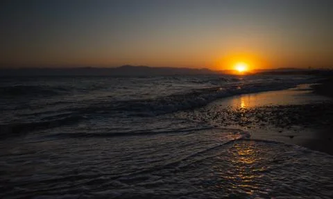 Summer sunset view on the beach Stock Photos