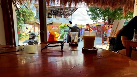 Summer table scene with tropical drink in Moalboal Stock Footage 336032999