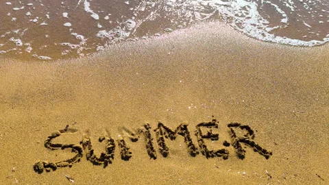 Summer text on beach sand in slow motion at golden hour Video stock 335758174