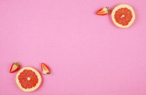 Summer theme background with ruby grapefruit on pink backdrop, with copy spac Stock Photos