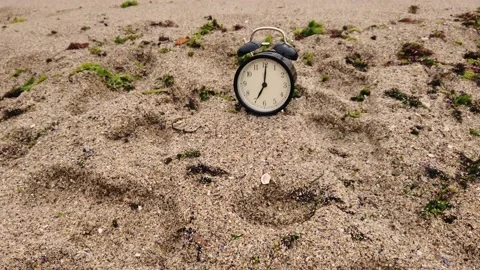 Summer time concept. Alarm clock on the beach sea sunrise background Stock Footage 142963814