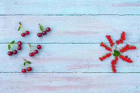 Summer time. Flat lay or top view of ripe red currant and cherry berries Stock Photos