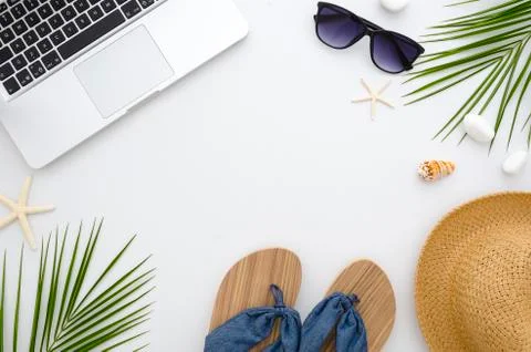 Summer time flat lay. Work and travel concept. Frame from laptop, green leaves Stock Photos