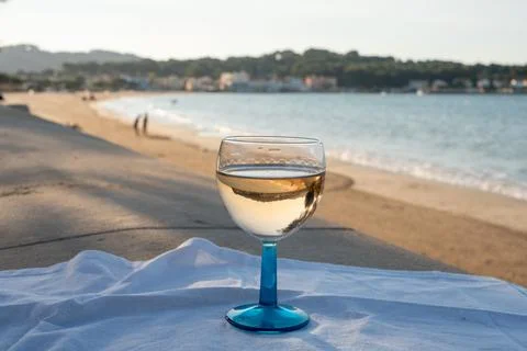 Summer time in Provence, drinking of cold gris rose wine on sandy beach and b Stock Photos