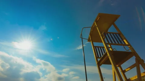 Summer timelapse, beach, lifeguard tower, sun, blue sky Stock Footage 49940569