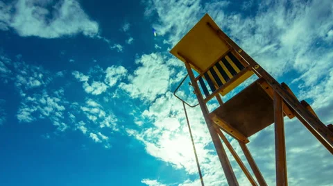 Summer timelapse, beach, lifeguard tower, sun, blue sky 24p Stock Footage 49977536