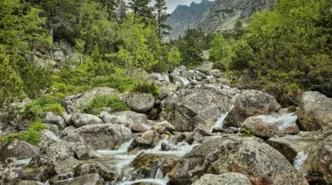 Summer timelapse of stream running through rocks in mountains, High tatras, Stock Footage 68370573