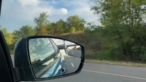 Summer travel, reflection in the rear view mirror. Side mirror of a car close-up Stock Footage 308967365