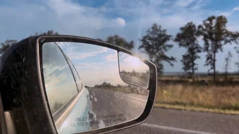 Summer travel, reflection in the rear view mirror. Side mirror of a car close-up Stock Footage 313754047