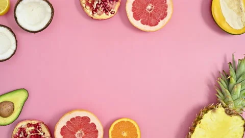 Summer tropic frame made with exotic fruits on pink background. stop motion Stock Footage 201696157