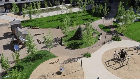 Summer urban space featuring play equipment and greenery Stock Footage 337937548