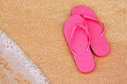 Summer vacation background flip flops on beach Stock Photos