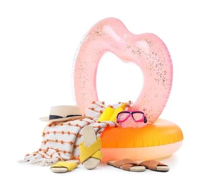Summer vacation beach essentials with heart-shaped inflatable ring, straw hat Stock Photos