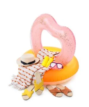 Summer vacation beach essentials with inflatable rings straw hat towel sunscr Stock Photos